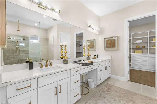 a bathroom with double sink and a mirror