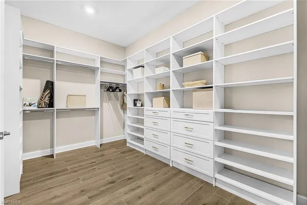 a view of walk in closet with empty racks
