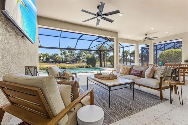 a living room with furniture and a large window with garden view