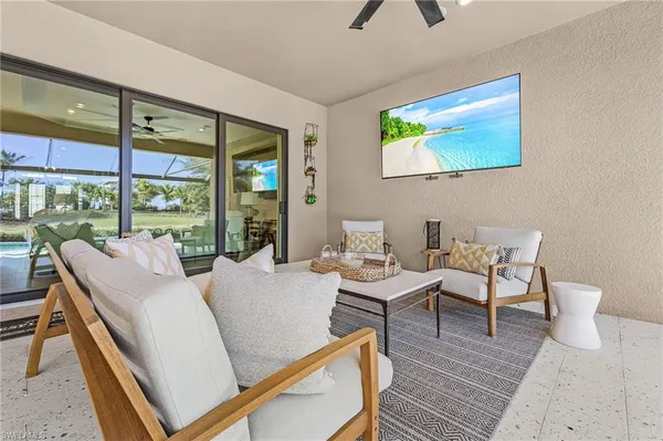 a living room with couches a coffee table and a large window with outer view