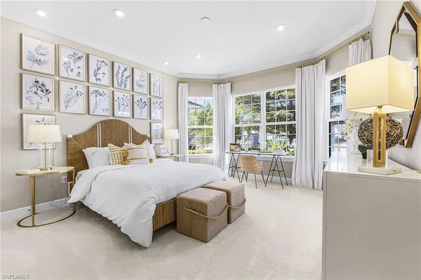 a bedroom with a large bed and a large window