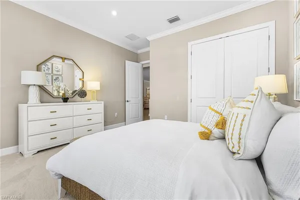 a bedroom with a bed and a dresser