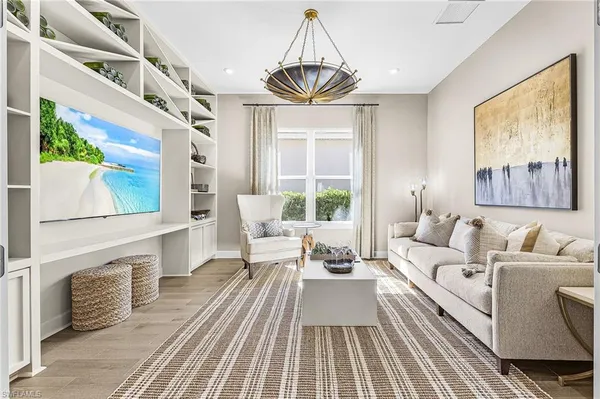 a living room with furniture a fireplace and a large window