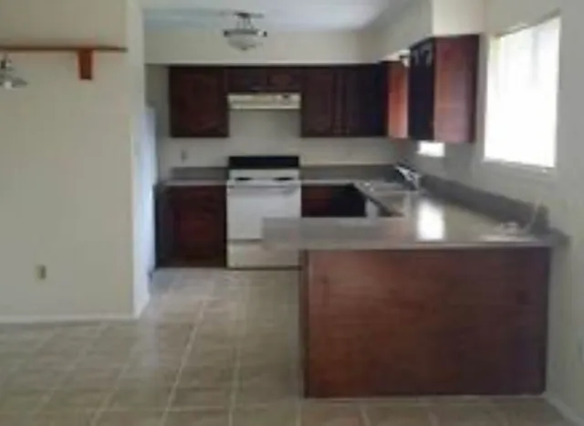 a kitchen with stainless steel appliances granite countertop a sink stove and a refrigerator