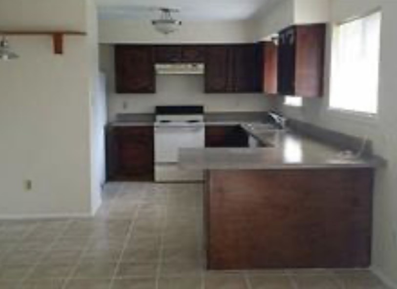 6222 Brookgate Drive Spring, TX 77373 - Photo 3 of 13 a kitchen with stainless steel appliances granite countertop a sink stove and a refrigerator