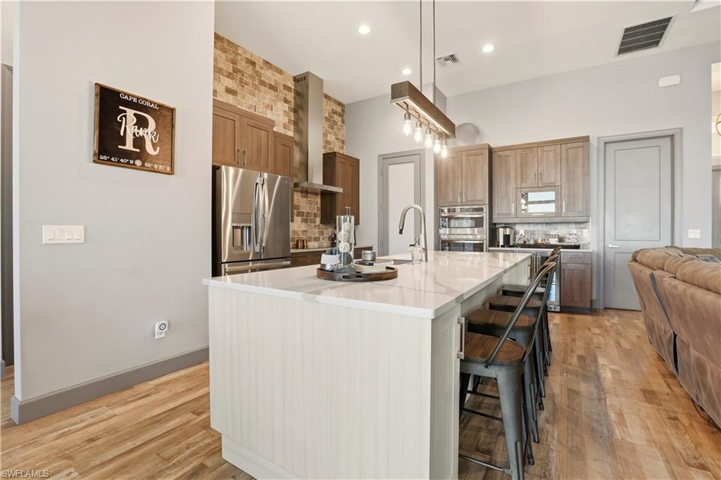 1616 Old Burnt Store Road North Cape Coral, FL 33993 - Photo 13 of 49 a kitchen with stainless steel appliances a sink stove and cabinets