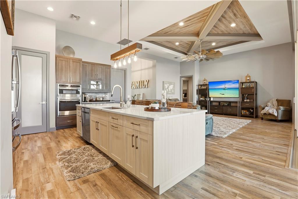 1616 Old Burnt Store Road North Cape Coral, FL 33993 - Photo 14 of 49 a kitchen with stainless steel appliances granite countertop a stove and a refrigerator