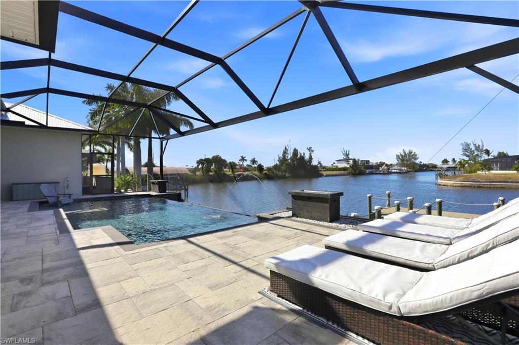 1616 Old Burnt Store Road North Cape Coral, FL 33993 - Photo 18 of 50 View of swimming pool with an infinity pool, a lanai, and a patio area with panoramic views across the entire back screen.