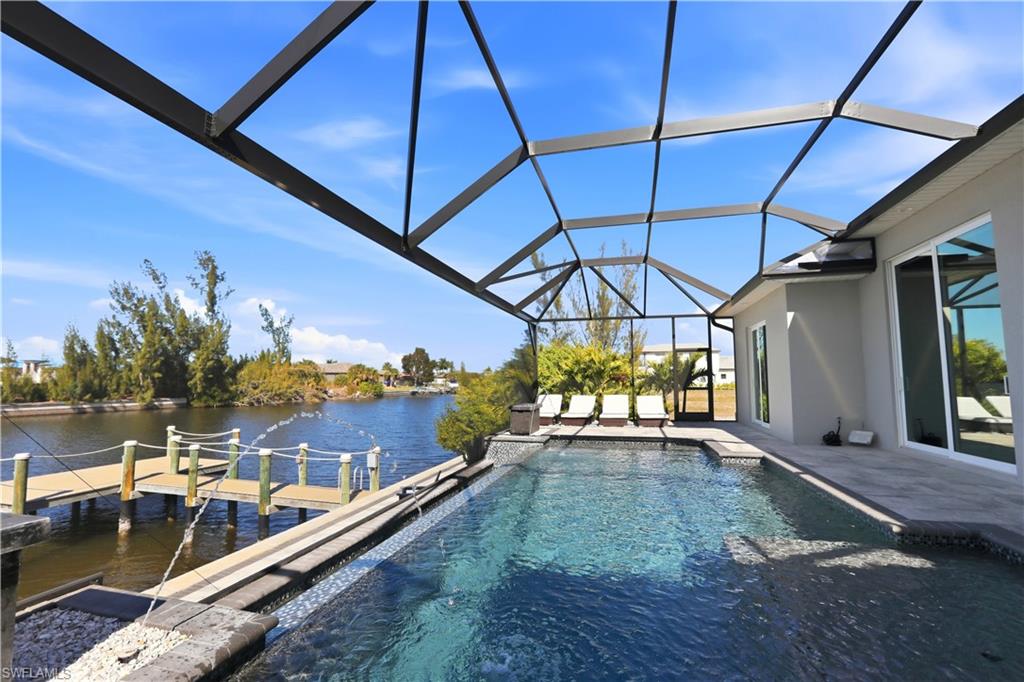 1616 Old Burnt Store Road North Cape Coral, FL 33993 - Photo 20 of 50 Outdoor pool with water features, lighting features, and sun shelves / tanning ledges.