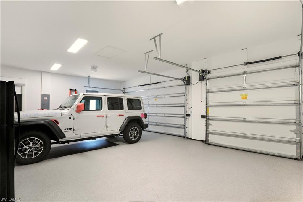1616 Old Burnt Store Road North Cape Coral, FL 33993 - Photo 27 of 50 Garage featuring freestanding refrigerator and electric panel