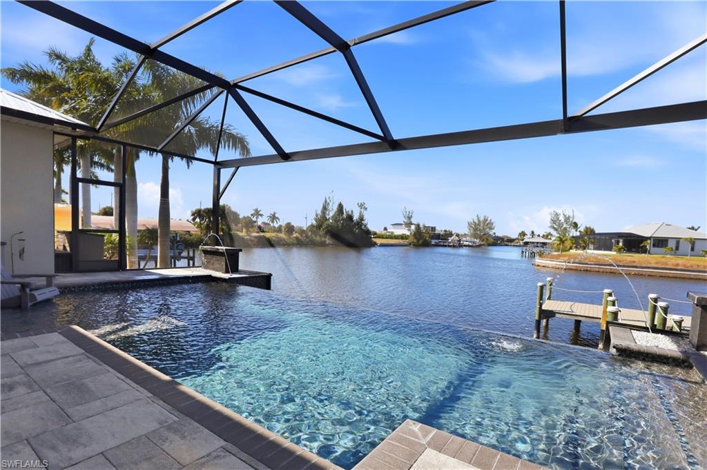 1616 Old Burnt Store Road North Cape Coral, FL 33993 - Photo 3 of 50 View of Infinity Edge swimming pool from the lanai and a deep water view with DIRECT ACCESS to the GULF with NO BRIDGES!