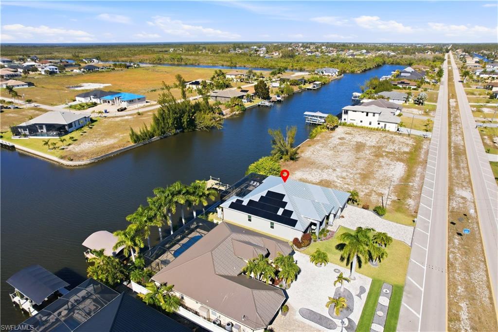 1616 Old Burnt Store Road North Cape Coral, FL 33993 - Photo 31 of 50 Aerial perspective of suburban area featuring a large body of water