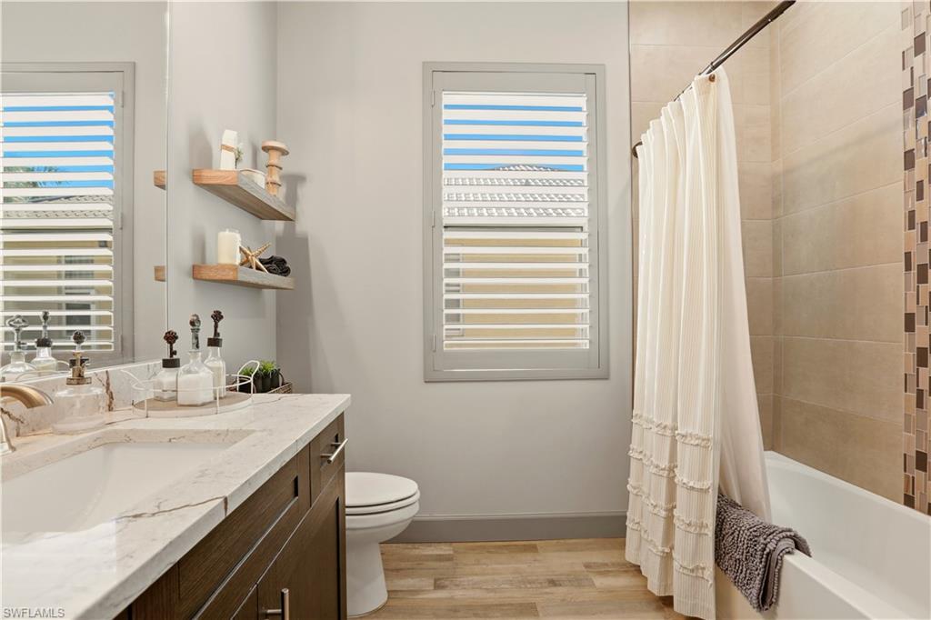 1616 Old Burnt Store Road North Cape Coral, FL 33993 - Photo 34 of 50 2nd Bathroom featuring shower / bath combination with curtain, vanity, and light wood-style flooring