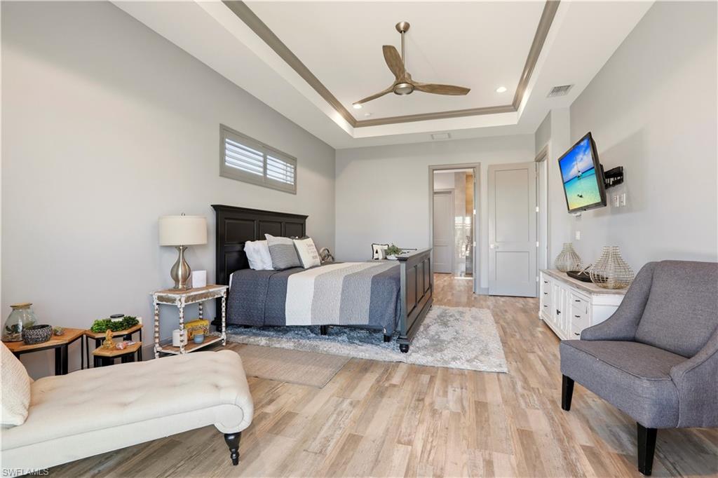1616 Old Burnt Store Road North Cape Coral, FL 33993 - Photo 43 of 50 Primary Bedroom with light wood finished floors, a ceiling fan, recessed lighting, and a raised ceiling