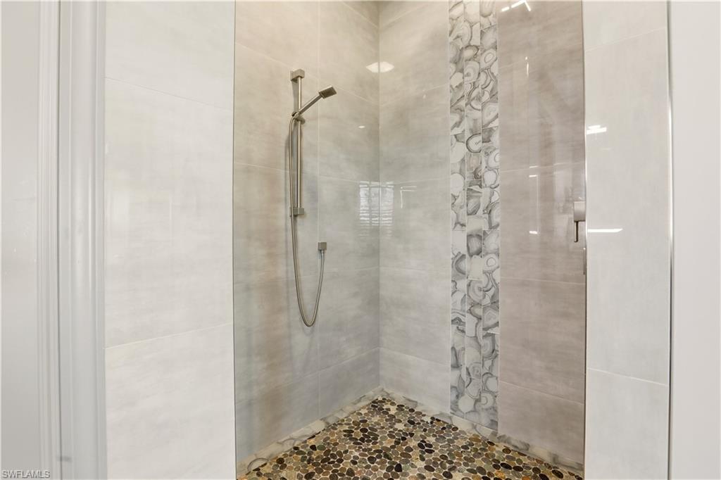 1616 Old Burnt Store Road North Cape Coral, FL 33993 - Photo 46 of 50 Primary Full bathroom featuring a tile shower with custom listello.