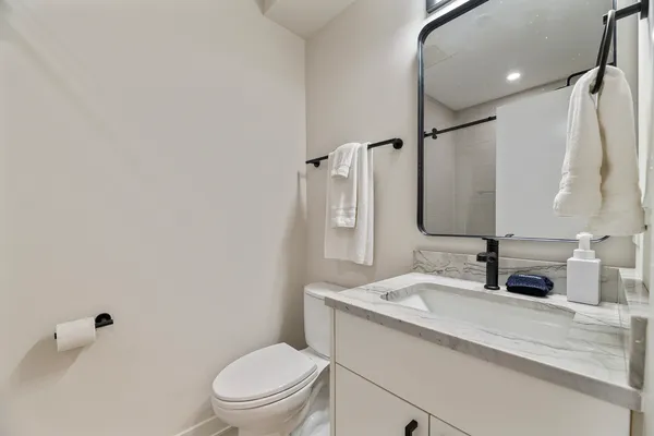 a bathroom with a sink toilet and shower
