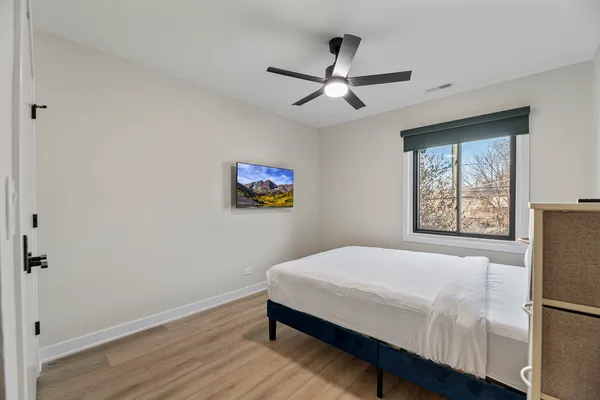 a bedroom with a bed and a window