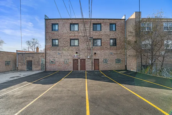 a brick building with a bench in front of it