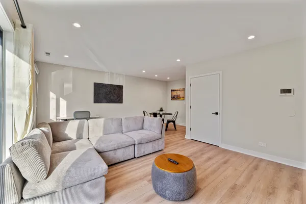 a living room with furniture and wooden floor