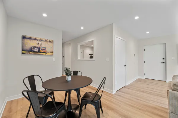 a view of a workspace with furniture and wooden floor