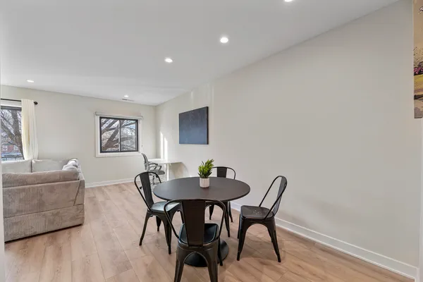 a dining room with furniture and wooden floor