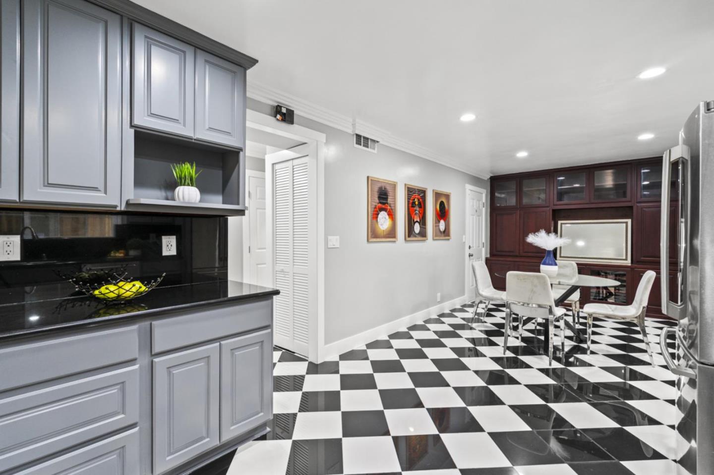 5150 Brookside Lane Concord, CA 94521 - Photo 16 of 51 a living room with a black white checkered floor with couches and a dining table with garden view
