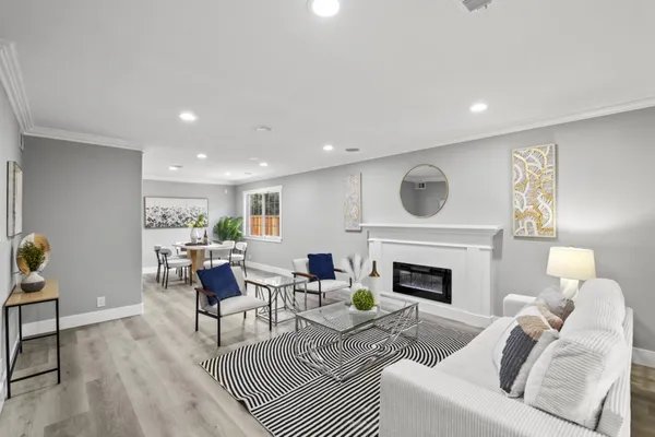 a living room with furniture a fireplace and a table