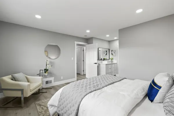 a spacious bedroom with a bed and a walk in closet