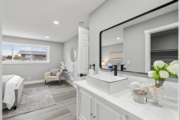 a bathroom with a sink vanity granite and toilet