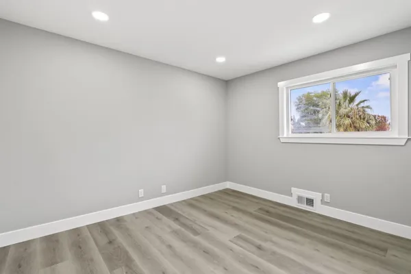a view of room with wooden floor and window