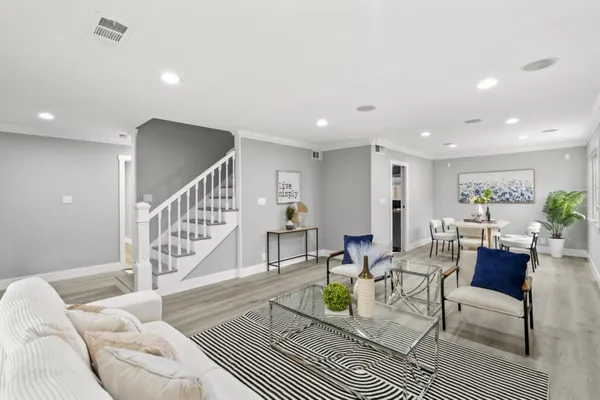 a living room with furniture and wooden floor