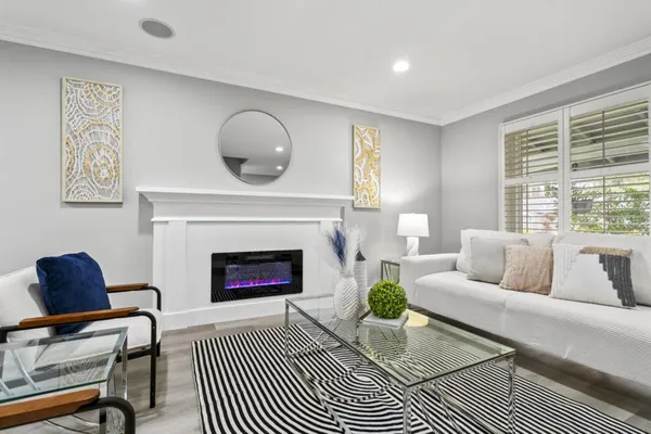 a living room with furniture a rug and a fireplace