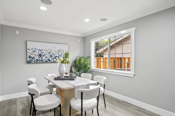 a dining room with furniture and window