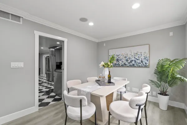 a dining room with furniture and wooden floor