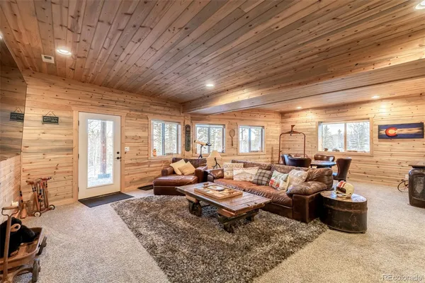 a living room with furniture fireplace and a large window