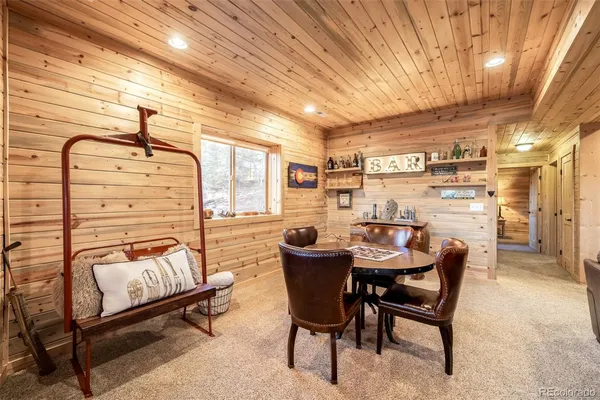 a dining room with furniture and a rug