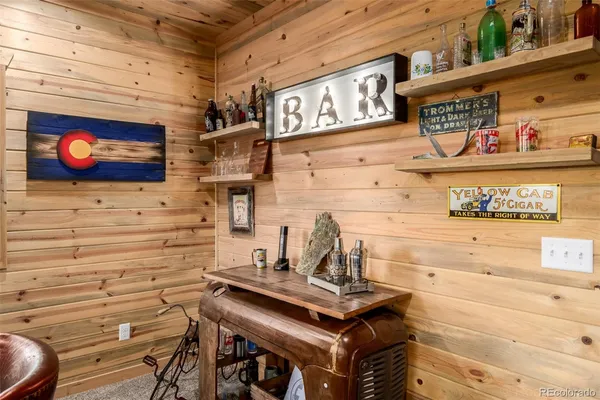 a table with chairs and paintings on the wall