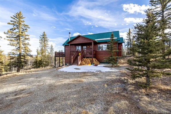 a view of a house with wooden deck