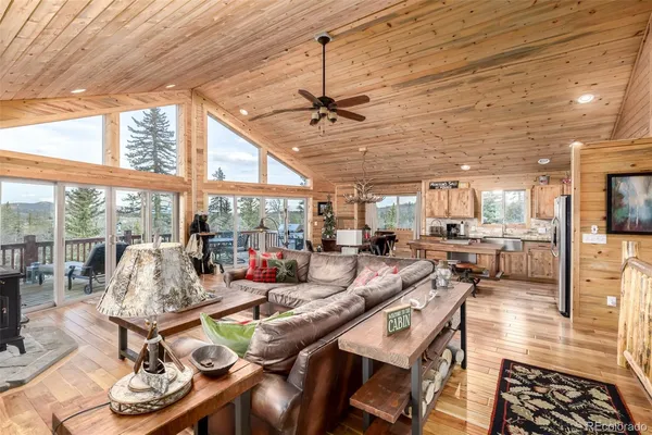 a view of a dining room with furniture water view and large windows