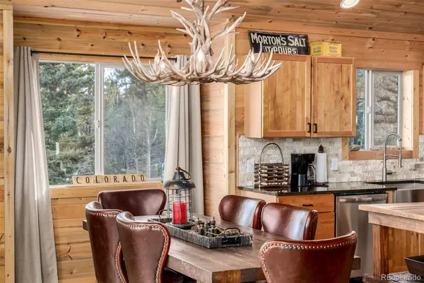 a kitchen with stainless steel appliances a sink a counter top space and a window