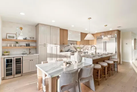 a large kitchen with a table and chairs