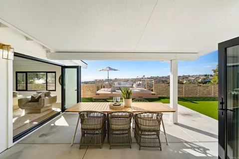a view of a balcony with chairs and a table