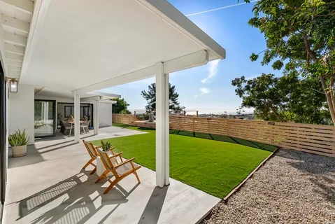 a view of a backyard with sitting area