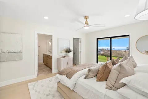 a bedroom with a large bed and a chandelier