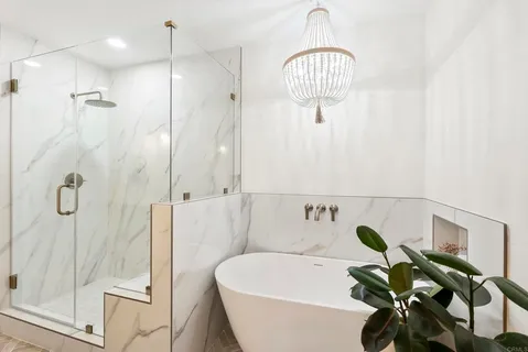 a bathroom with a bathtub a sink and a shower