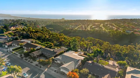 an aerial view of residential building with green space