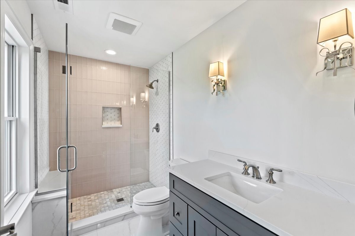 1 West Penny Road South Barrington, IL 60010 - Photo 23 of 30 a bathroom with a granite countertop sink a toilet and shower