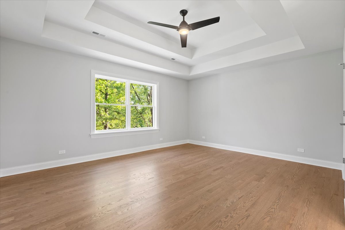 1 West Penny Road South Barrington, IL 60010 - Photo 24 of 30 an empty room with wooden floor ceiling fan and windows