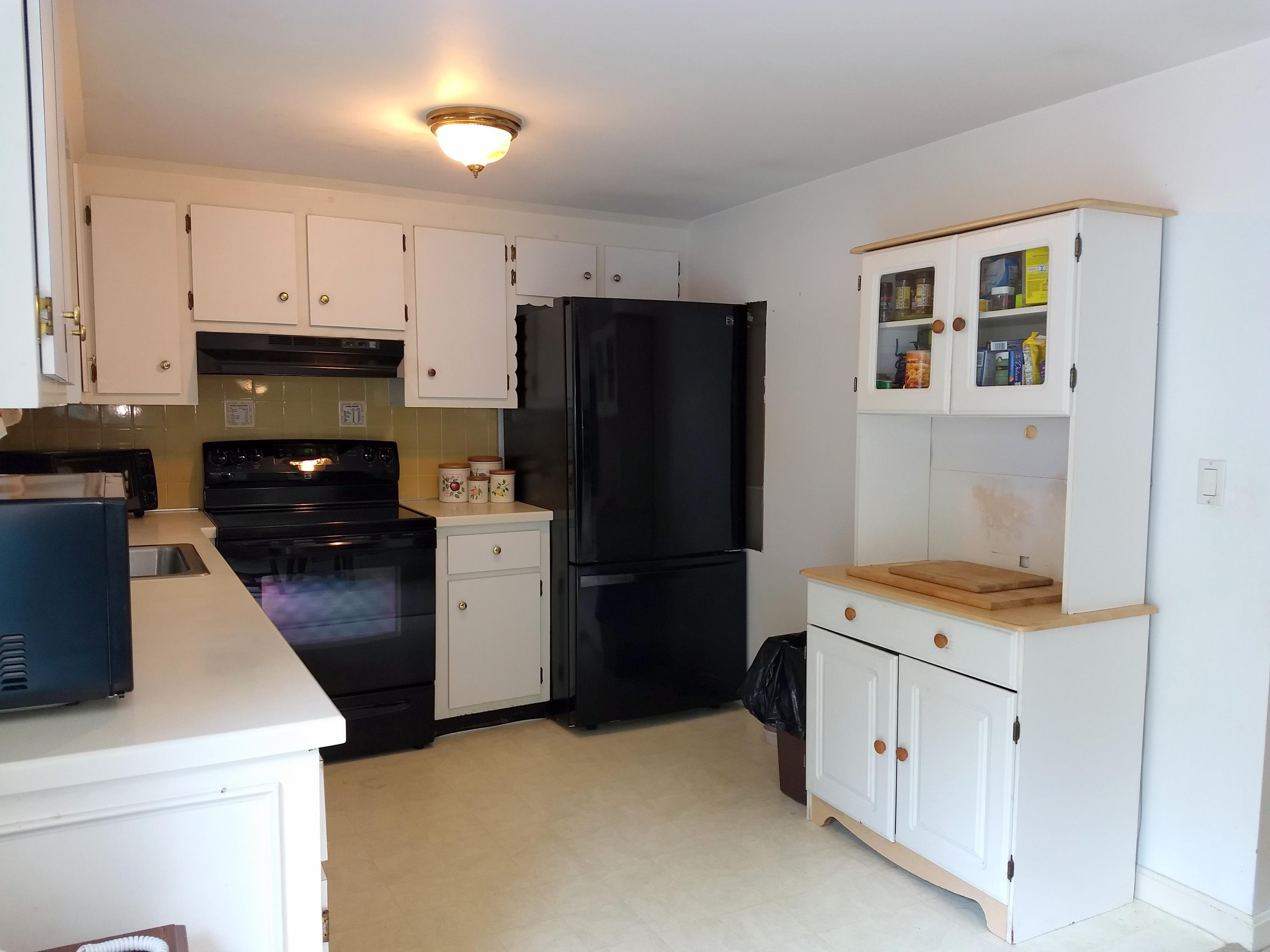 88 Cedric Road Centerville, MA 02632 - Photo 6 of 25 a kitchen with a refrigerator stove and cabinets