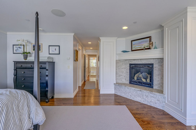 9699 Bypass Road, Unit 5 Alta, UT 84092 - Photo 45 of 54 Bedroom featuring a corner fireplace with a stone surround and hearth, hardwood flooring, recessed lighting, and crown molding